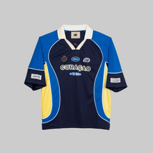 Load image into Gallery viewer, Blue and yellow sports jersey with 'Curaçó' text on a light gray background