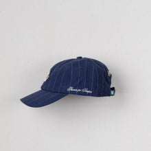 Load image into Gallery viewer, A navy blue pinstripe baseball cap with white embroidered text on the side, displayed against a plain light gray background.
