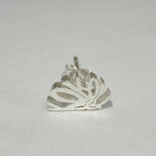 Load image into Gallery viewer, A small silver pendant with a cutout leaf design and a loop at the top, photographed on a plain light gray background.
